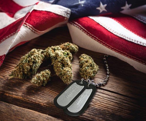 dog tags with cannabis flower and american flag on a wooden table